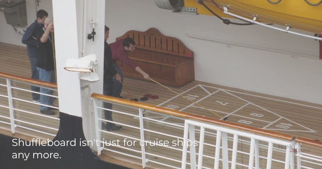People playing shuffleboard on a cruise ship.