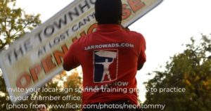 Image of a guy practicing spinning a sign.