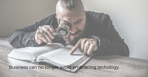 Image of a funny man reading a book with a magnifying glass to show that when you're locked down, you must embrace technology.