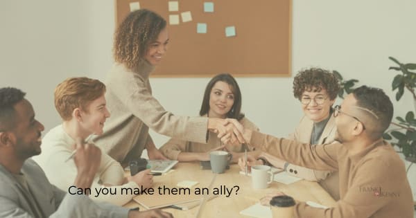 Overcoming naysayers by making them an ally: image of people in a meeting.