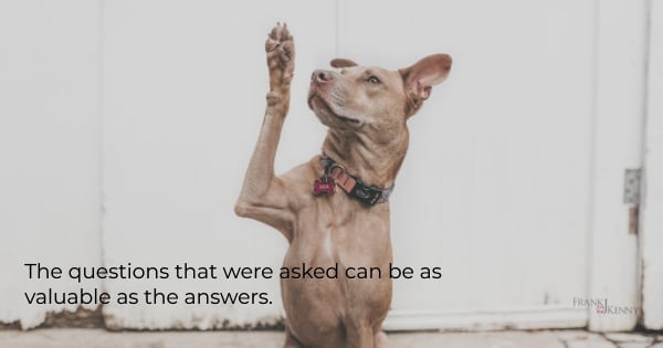Image of a dog raising his paw as if he were asking a question.
