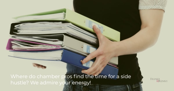 Picture of a woman holding binders full of paperwork. 