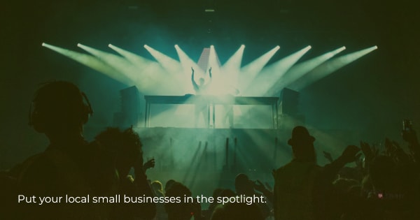 Someone on stage in the spotlight to illustrate the idea of small business Saturday spotlights (i.e. highlights)