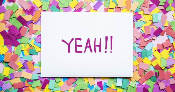 Image of the word Yeah!! on a background of confetti.